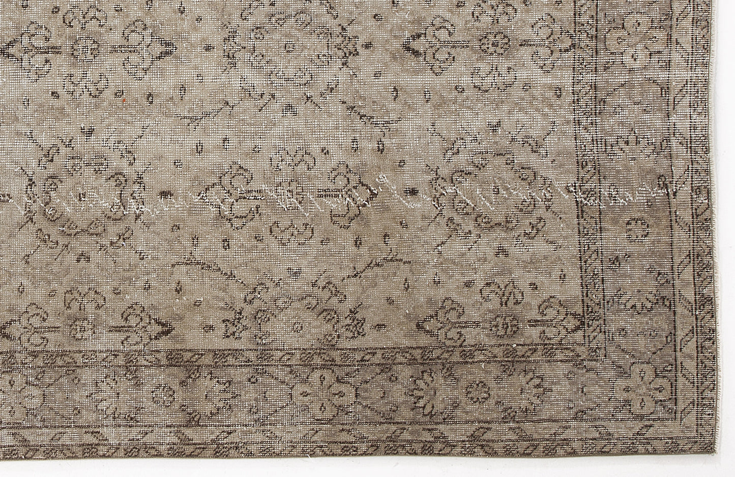Taupe and brown distressed rug with a traditional floral medallion pattern and a detailed border.