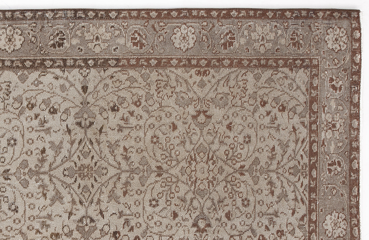 Taupe and brown traditional rug with a detailed floral medallion pattern and a decorative border.