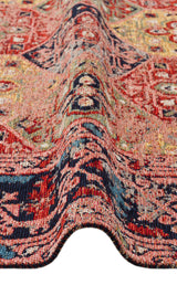 A close-up of the Anatolian Weave - Washable Kilims - AND01 showcases multicolour chenille polyester with red, navy blue, and tan geometric and abstract tribal patterns and a wave-like fold through the center