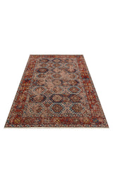 Nomad Spirit - Washable Kilims - AND03 is a rectangular flatwoven rug with intricate geometric and floral patterns in red, blue, and beige. It features a prominent border and a soft, slightly worn tribal-ethnic look