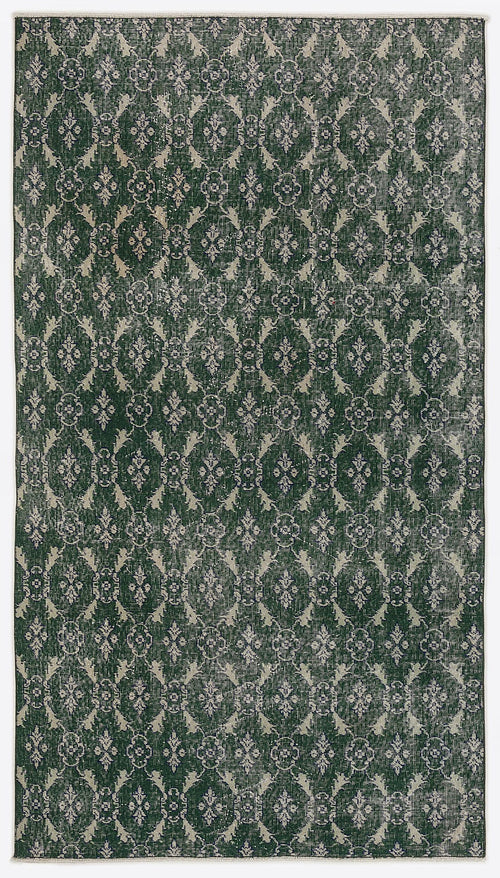 Load image 1 in gallery view. Dark green and cream distressed rug featuring a repeating damask-inspired trellis pattern.