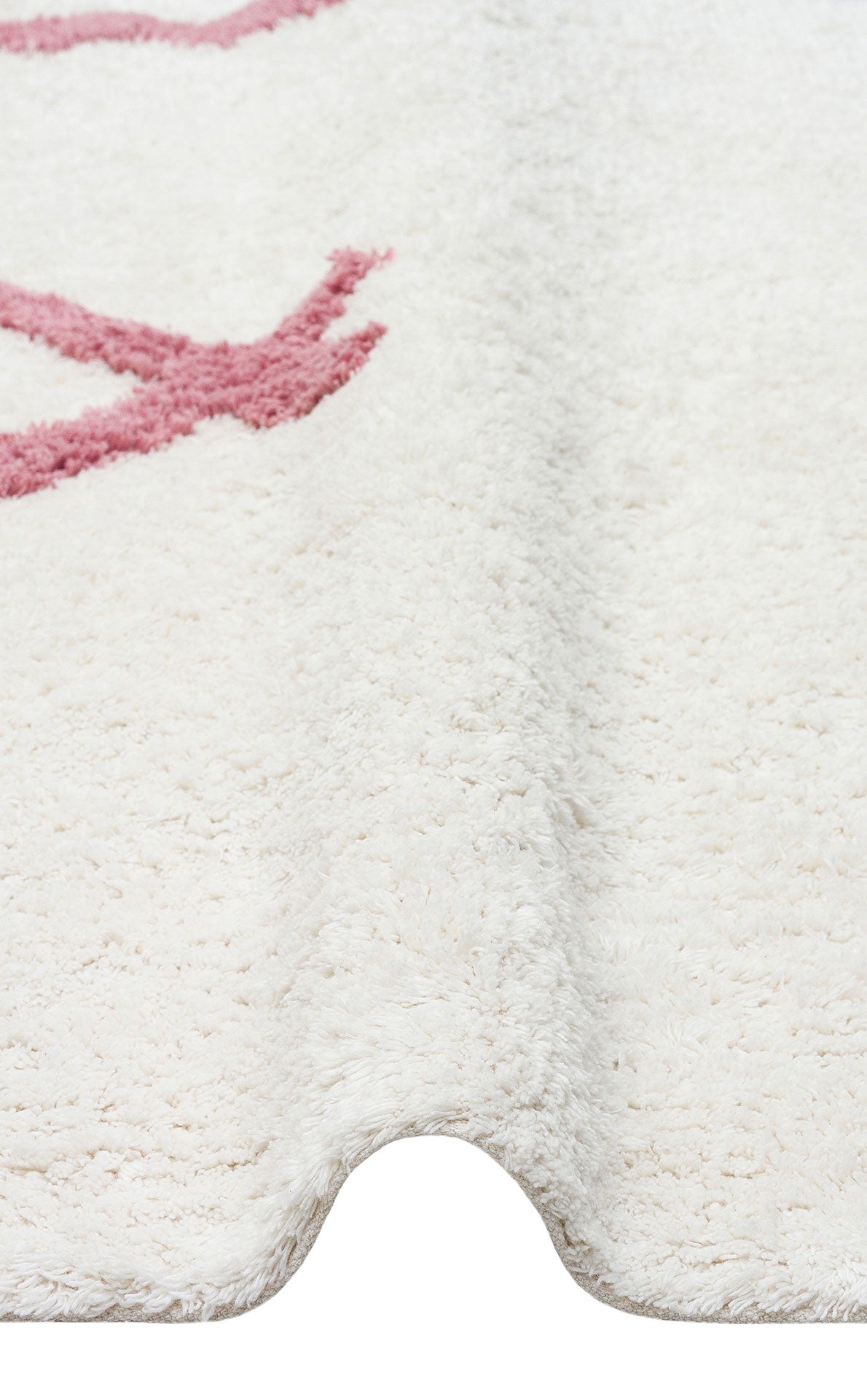 A close-up of the Nursery Nest - Washable Shaggy - CBN04 rug in cream, with a subtle wavy fold and partial pink pattern—an ultra-cozy, washable shaggy rug ideal for any nursery or living space.