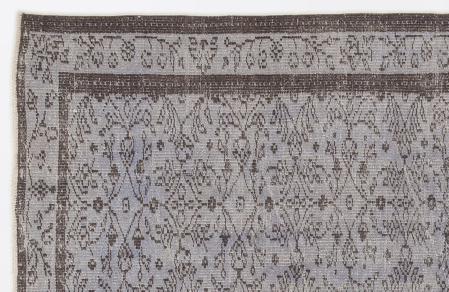 Grey and charcoal rug with a distressed, traditional medallion pattern and a wide decorative border.