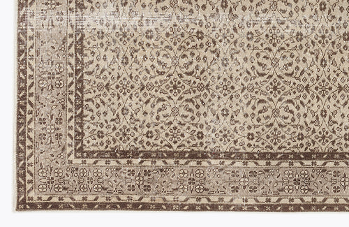 Load image 1 in gallery view. Taupe and dark brown rug with a distressed, intricate floral medallion pattern and a geometric border.
