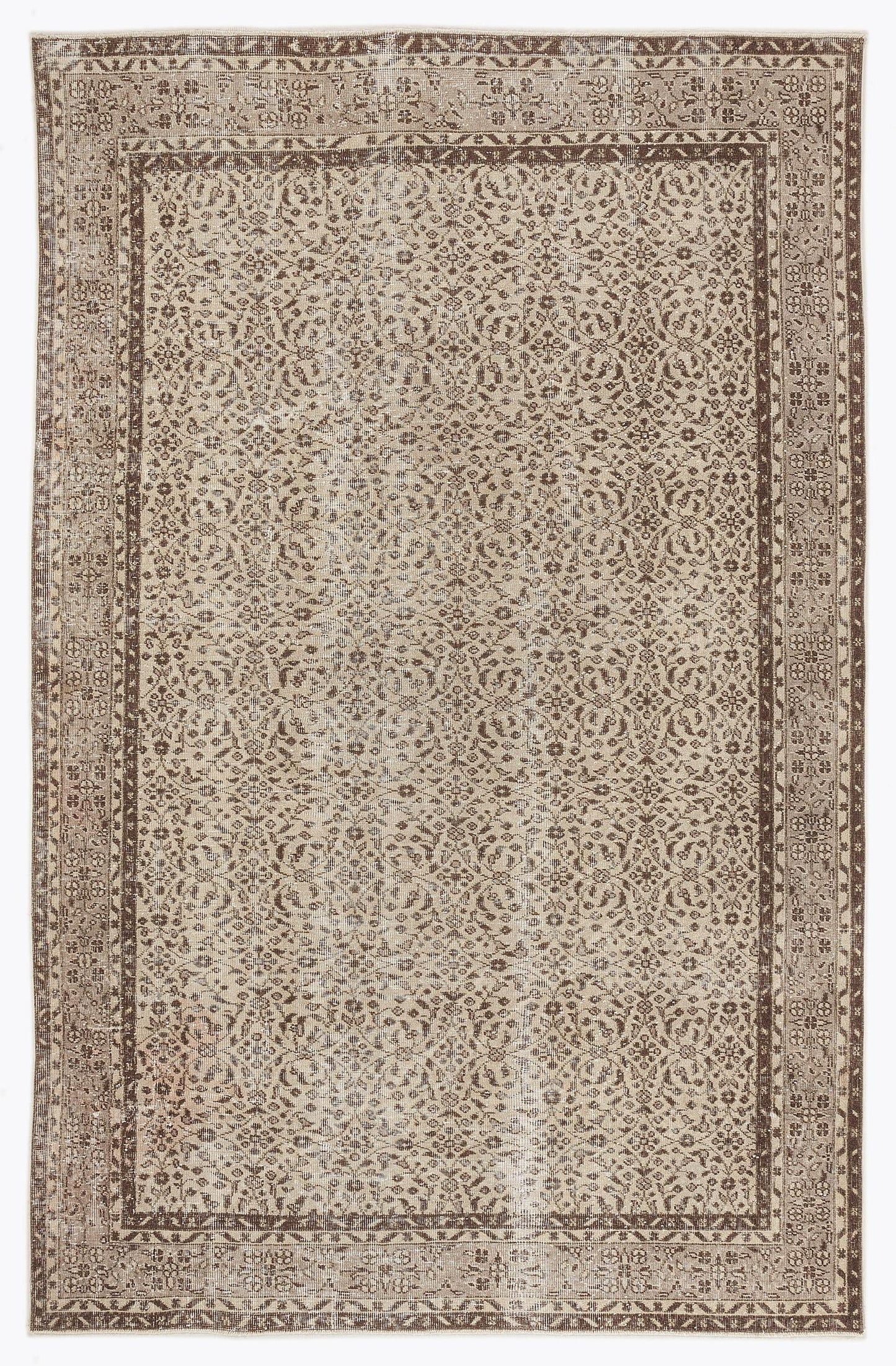 Brown and beige vintage-style rug with an intricate floral medallion pattern and a wide decorative border.
