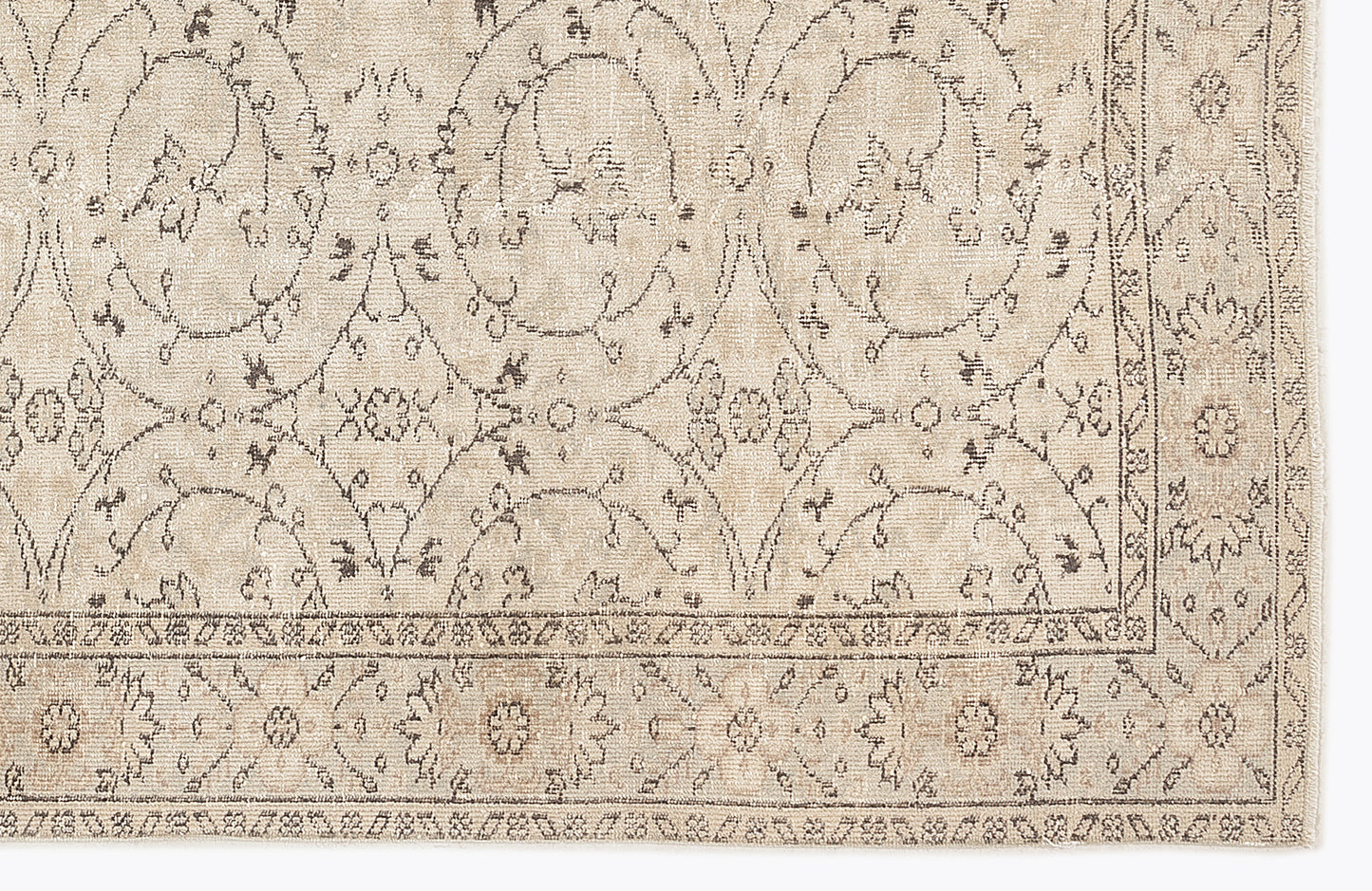 Beige and taupe rug with a distressed traditional floral medallion pattern and a decorative border.