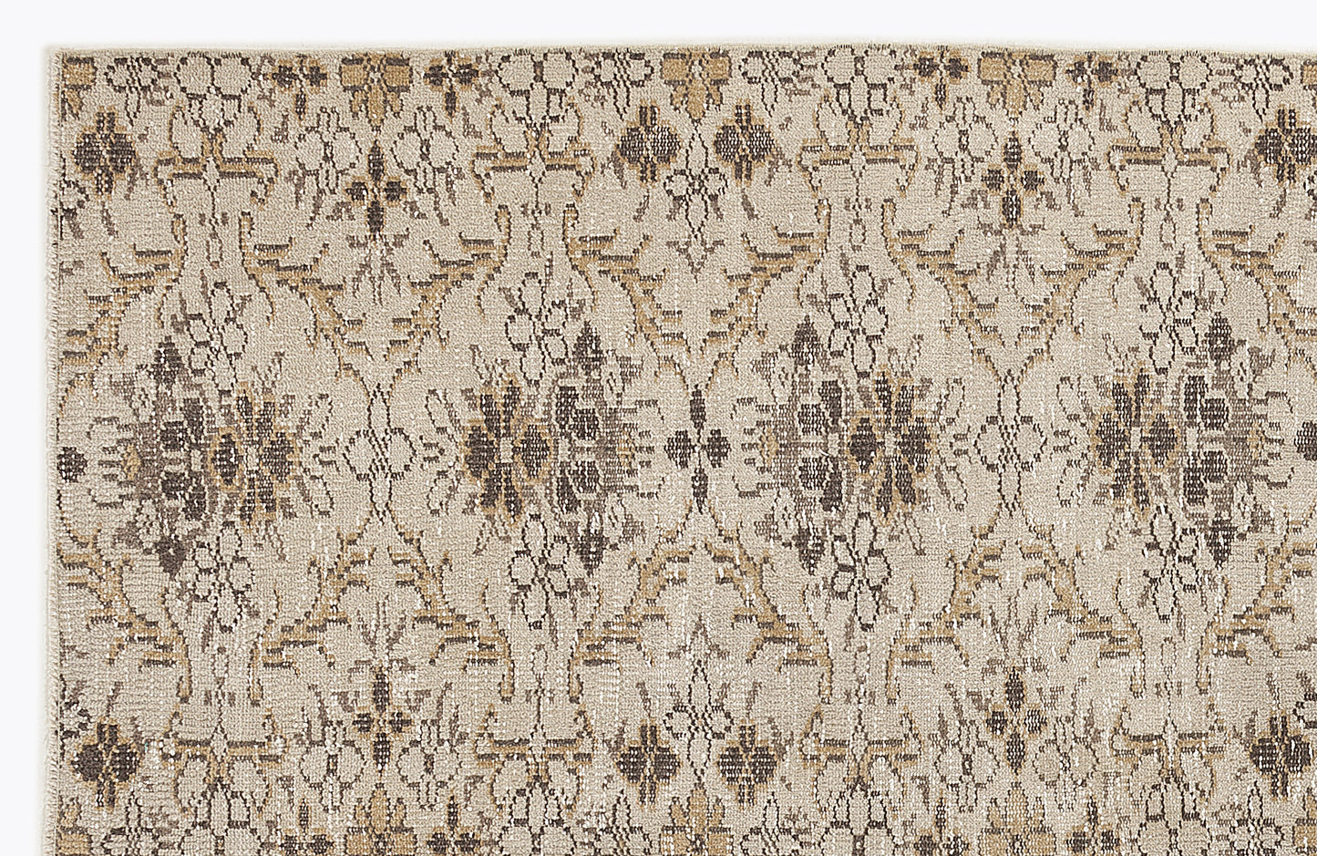 Beige rug with a repeating dark brown and tan floral medallion pattern on a textured, neutral background.