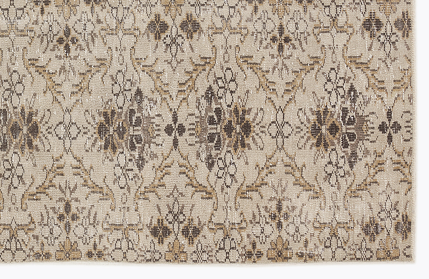 Beige and brown rug with a repeating distressed floral medallion pattern.