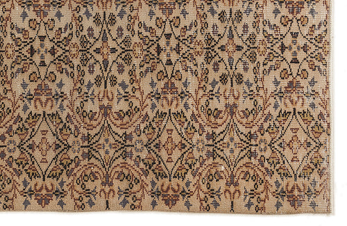 Load image 1 in gallery view. Tan rug with a repeating black, brown, and muted blue floral damask pattern in a diamond grid layout.