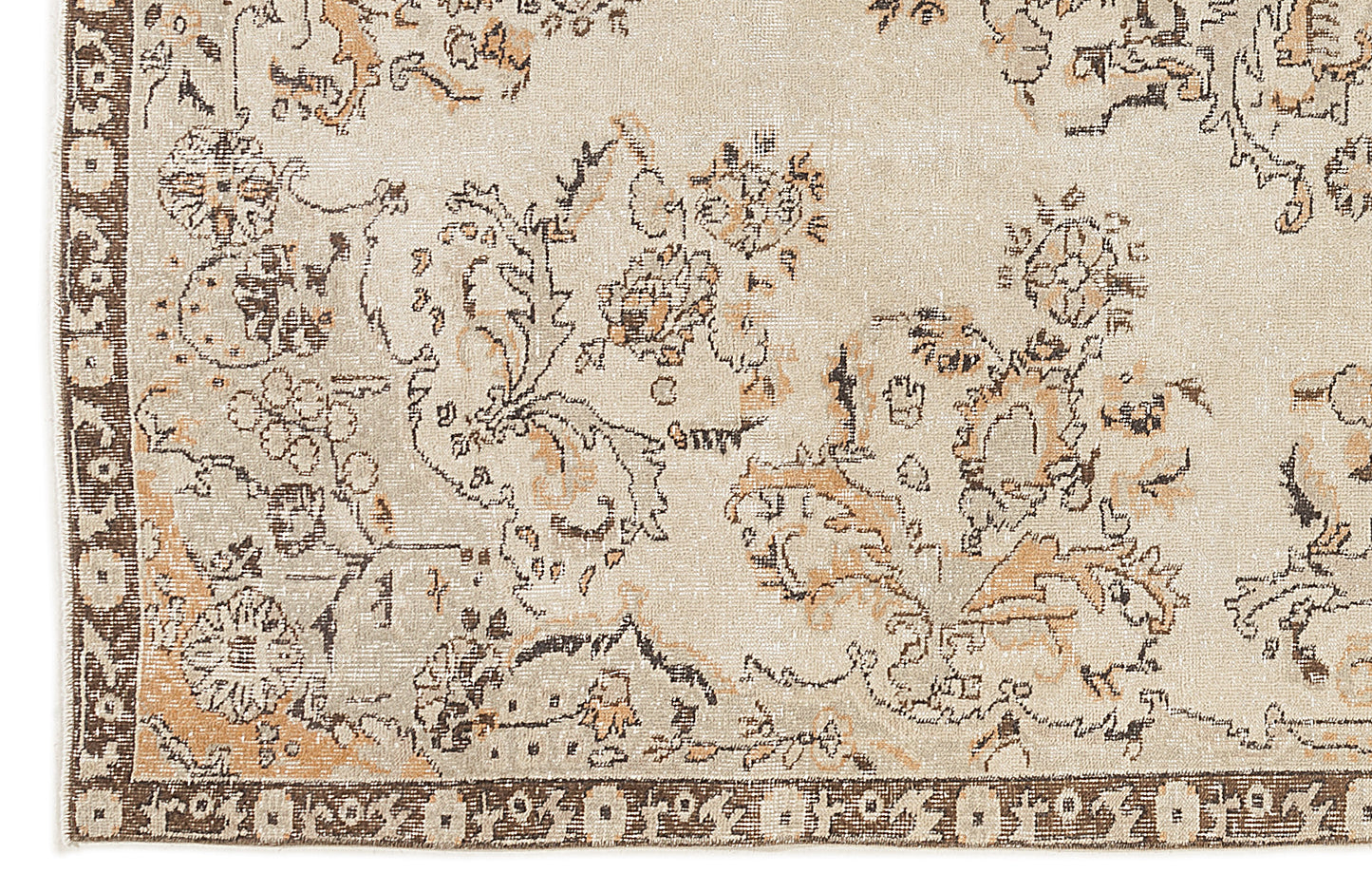Beige rug with a distressed floral pattern in brown and tan, featuring a dark brown geometric border.