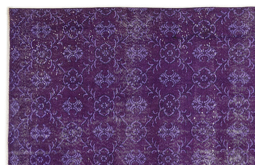 Load image 1 in gallery view. Deep purple rug with a distressed, repeating floral medallion pattern and white woven texture.