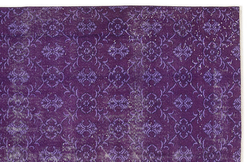 Load image 1 in gallery view. Deep purple rug with a repeating distressed floral medallion pattern on a white background.