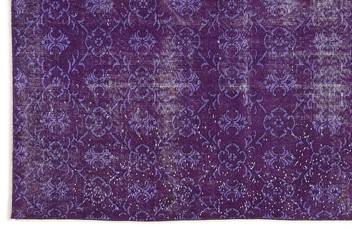 Load image 1 in gallery view. Deep purple rug with a distressed, repeating floral medallion pattern and white woven texture.