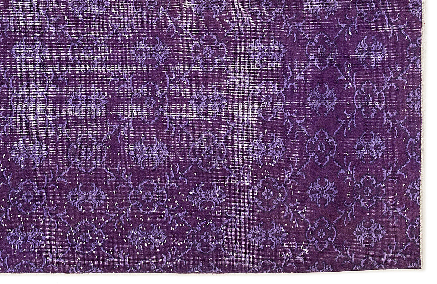 Deep purple vintage-style rug with a distressed floral medallion pattern and white worn accents.