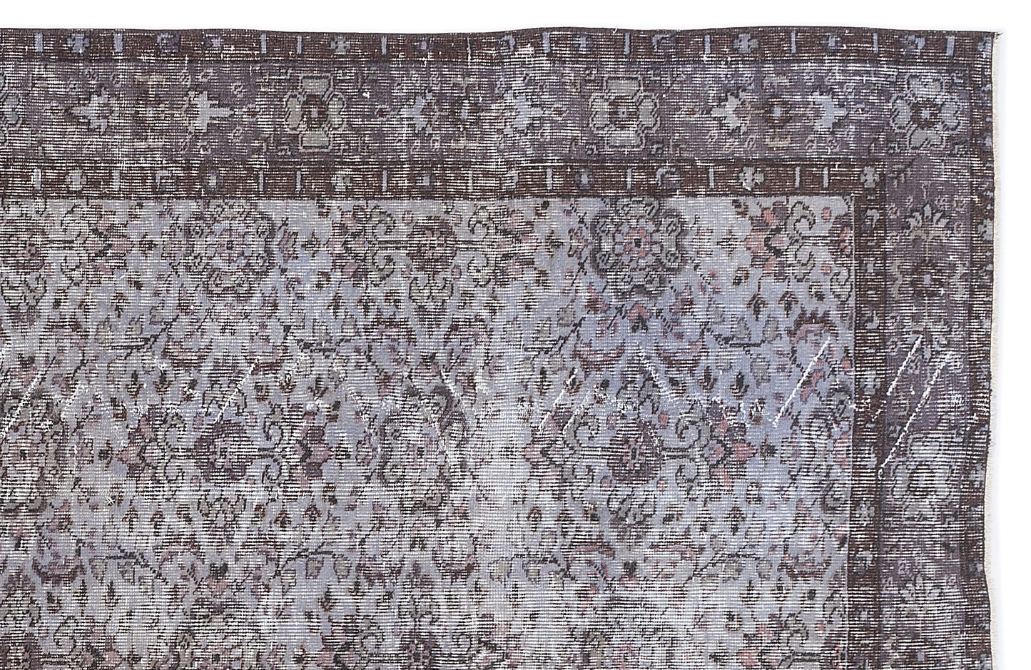 Distressed charcoal and light blue traditional rug with a floral medallion pattern and a wide decorative border.