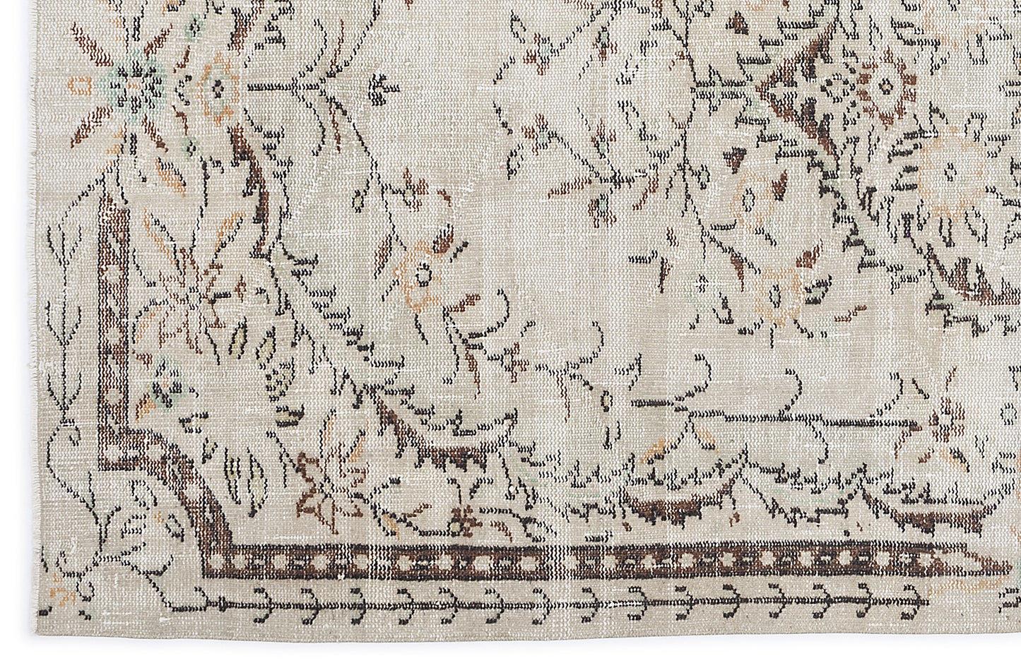 Beige rug with a distressed floral medallion pattern in brown, tan, and muted green accents.