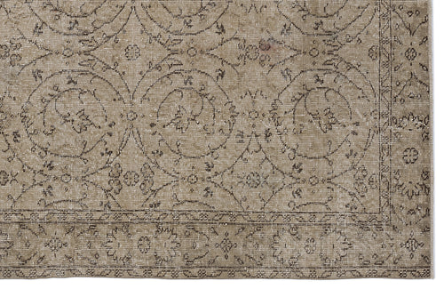 Load image 1 in gallery view. Taupe and brown vintage-style rug with a distressed floral medallion pattern and a decorative border.