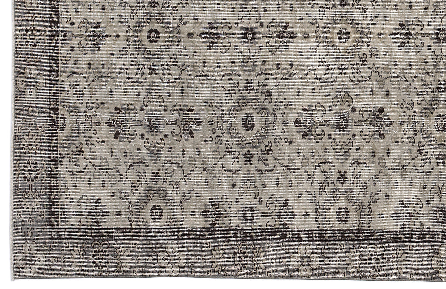 Grey and charcoal distressed rug with a traditional floral medallion pattern and a wide decorative border.