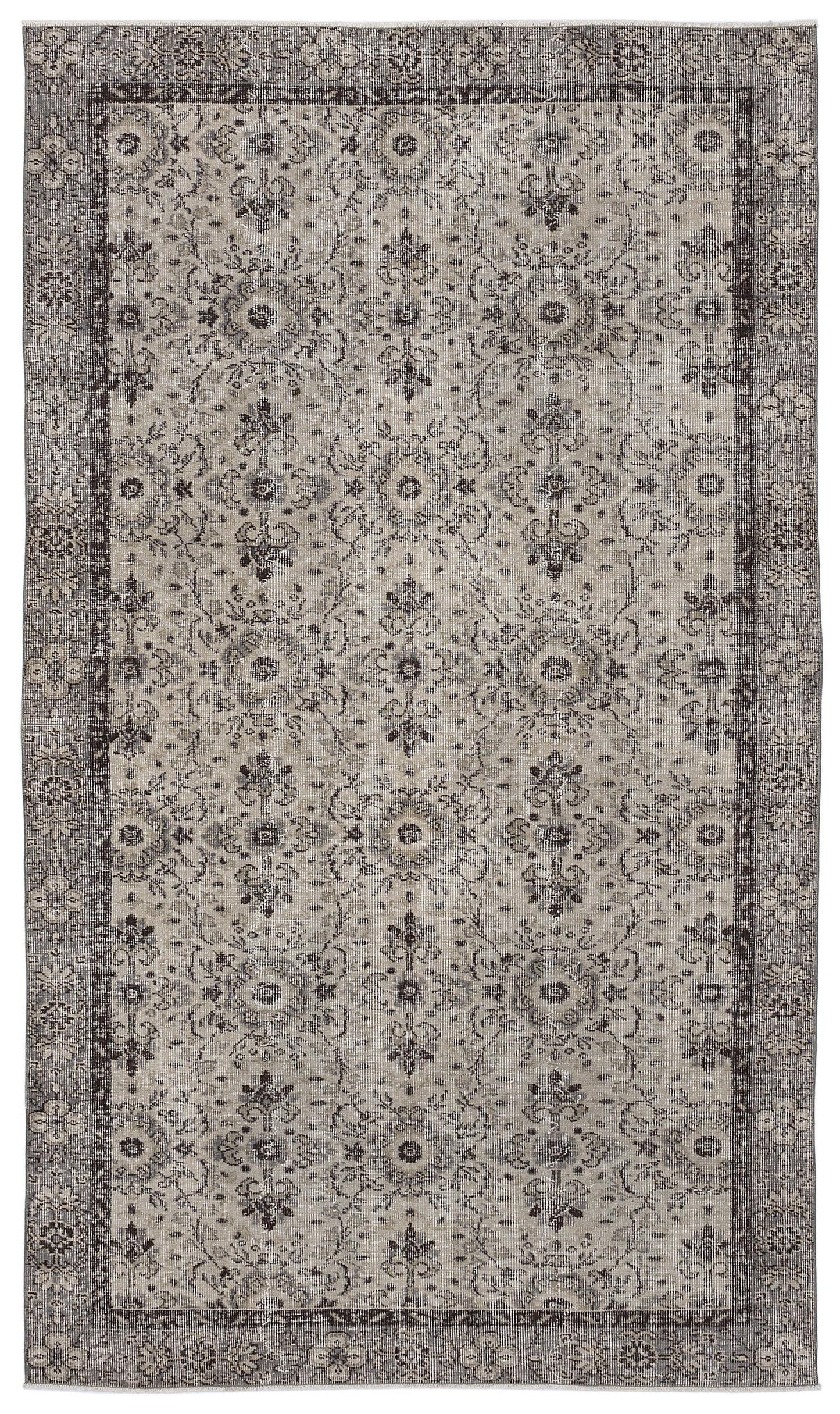 Grey and charcoal distressed rug with a traditional floral medallion pattern and a wide decorative border.