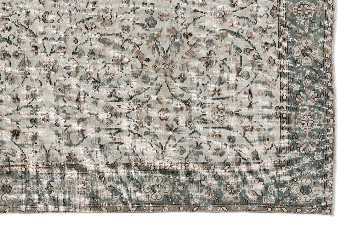 Beige, sage green, and muted pink traditional rug with a distressed floral medallion pattern and a decorative border.