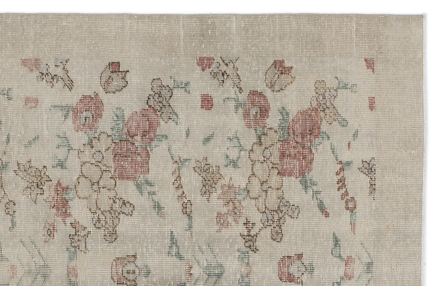 Beige vintage-style rug with a faded floral pattern in muted red, green, and brown tones.