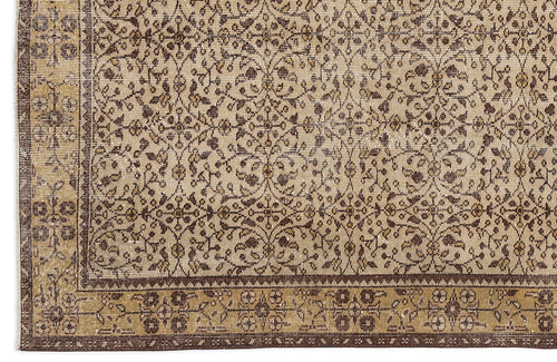 Load image 1 in gallery view. Beige and brown traditional rug with a repeating floral vine pattern and a wide decorative border.
