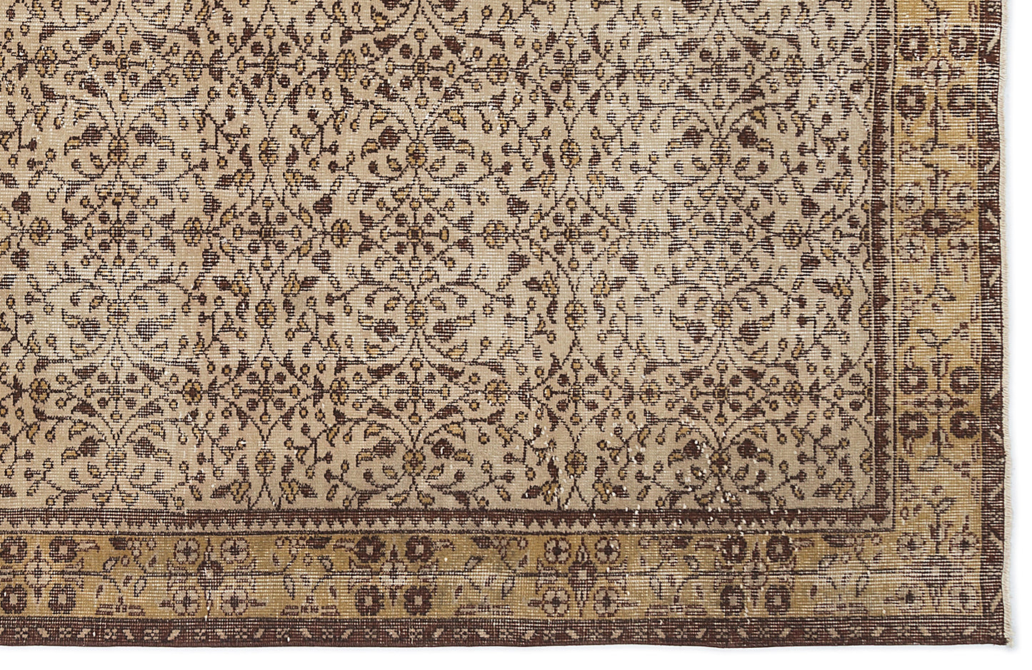 Beige and brown vintage-style rug with a repeating floral vine pattern and a decorative border.