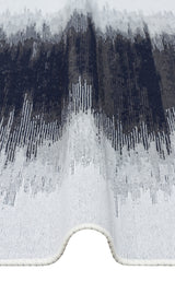 A close-up of the Charcoal Frame - Washable Double-Sided Kilims - AR40, a black and white rug with wavy edges, showcasing an abstract pattern in dark blue, gray, and white with vertical textured lines.