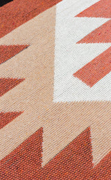 Close-up of the Artisan Mesh - Washable Double-Sided Kilims - AR39, highlighting its geometric pattern in beige, white, and red with sharp angles and rich textured detail.