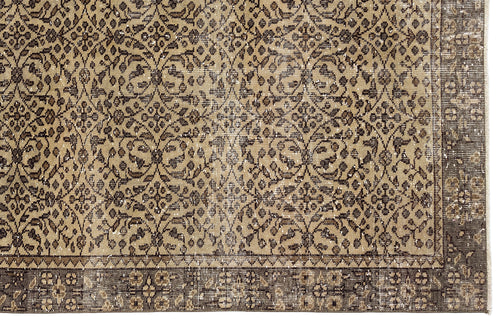 Load image 1 in gallery view. Tan and dark brown vintage-style rug with a repeating floral medallion pattern and a wide, detailed border.