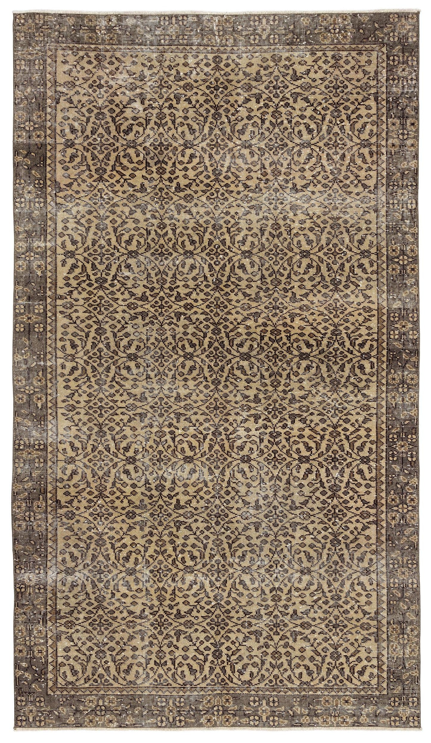 Distressed brown and tan rug with a traditional floral medallion pattern and a wide decorative border.