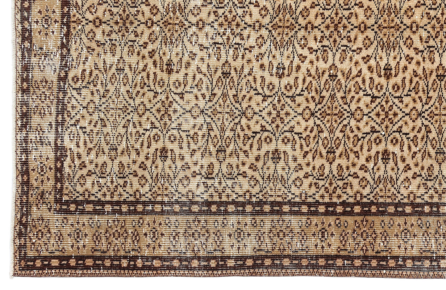 Tan and dark brown vintage-style rug with an intricate floral medallion pattern and a geometric border.