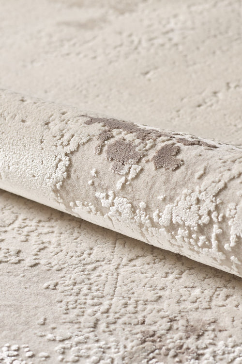 Load image 1 in gallery view. A close-up of the Abstract Blitz Premium Rug - Gold (M658F), showcasing its rolled-up, machine-made design with a textured, raised gold pattern on a matching carpeted surface.