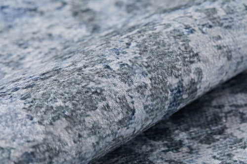 Load image 1 in gallery view. A close-up of the Abstract Oasis - Washable Rug - JR144 (Custom Size) highlights its blue-gray, flat weave design with a textured, mottled surface and soft, raised fibers—ideal for those wanting a stylish, allergy-friendly rug.