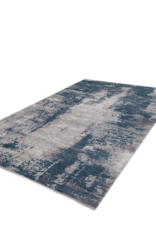 Load image 1 in gallery view. The Abstracta Blue Premium Rug - 1004F is a rectangular machine-made rug in blue, gray, and light beige with a distressed abstract pattern, shown on a white background.
