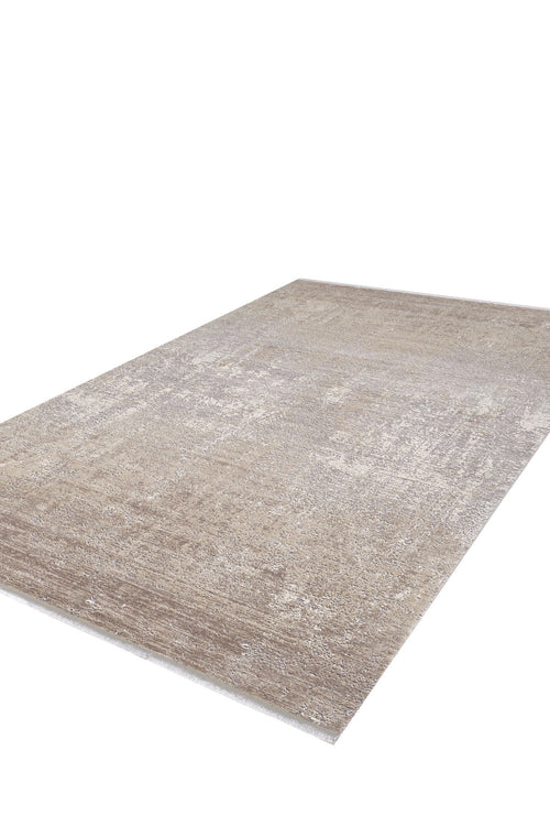 Load image 1 in gallery view. The Abstracta Creme Premium Rug - 1004B is a large rectangular acrylic-viscose rug featuring a subtle distressed pattern in beige and light brown, shown on a white background.