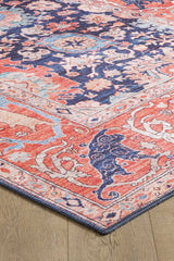 A close-up of the Aegis Handmade-Design Washable Rug - LCC3029 shows its intricate coral, blue, cream, and navy floral and animal patterns on a wooden floor—ideal for high-traffic areas.
