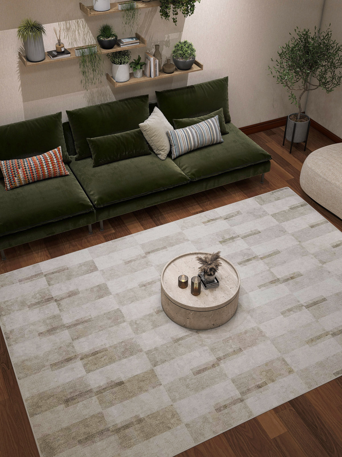 Modern living room featuring a green velvet sofa, decorative pillows, potted plants, a round beige coffee table, and the Aged Elegance - Washable Rug - JRN37 with a subtle chevron pattern—ideal for high-traffic wooden floors.