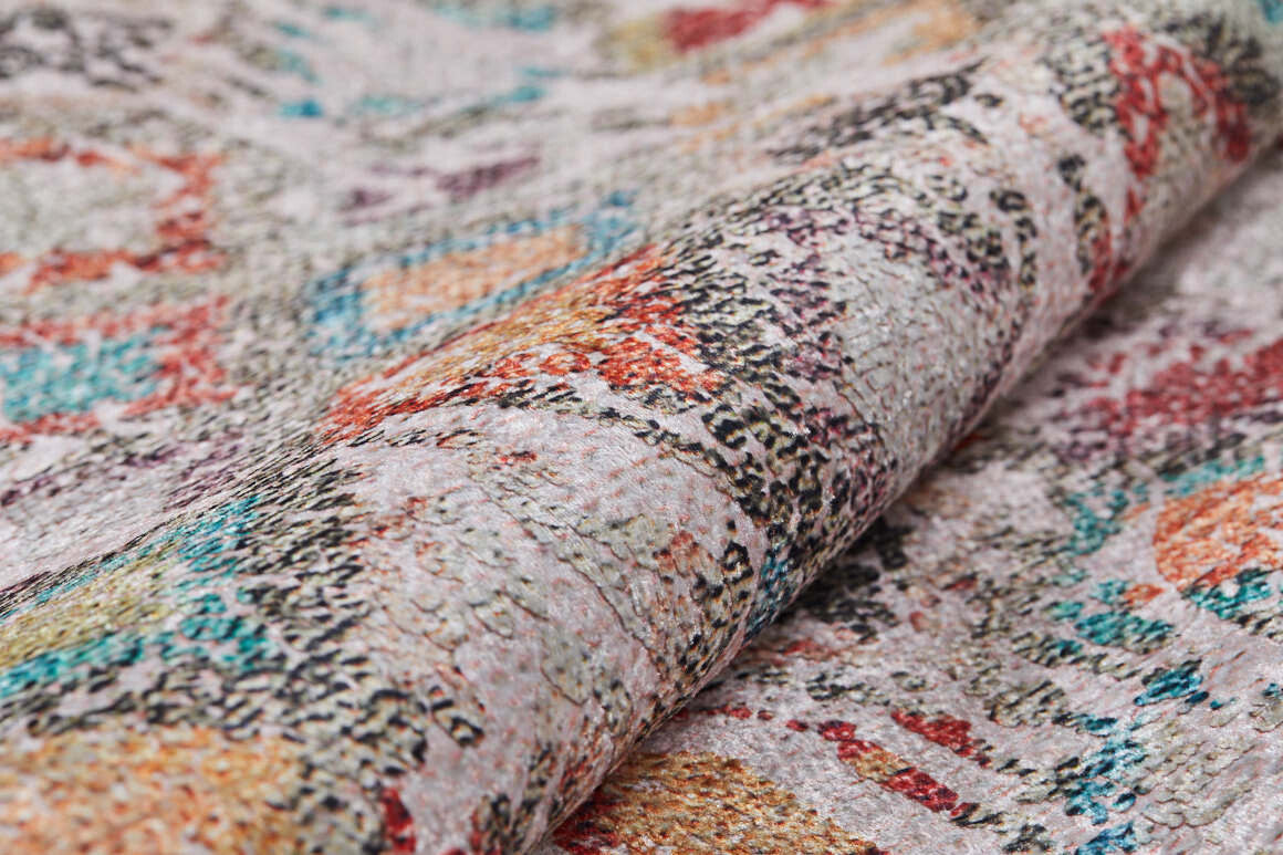 A close-up of the Aged Mosaic - Washable Rug - JR1096 (Custom Size) shows its abstract multicolor patterns in orange, teal, yellow, and gray on a light background—intricate details and durable surface make it perfect for high-traffic areas.