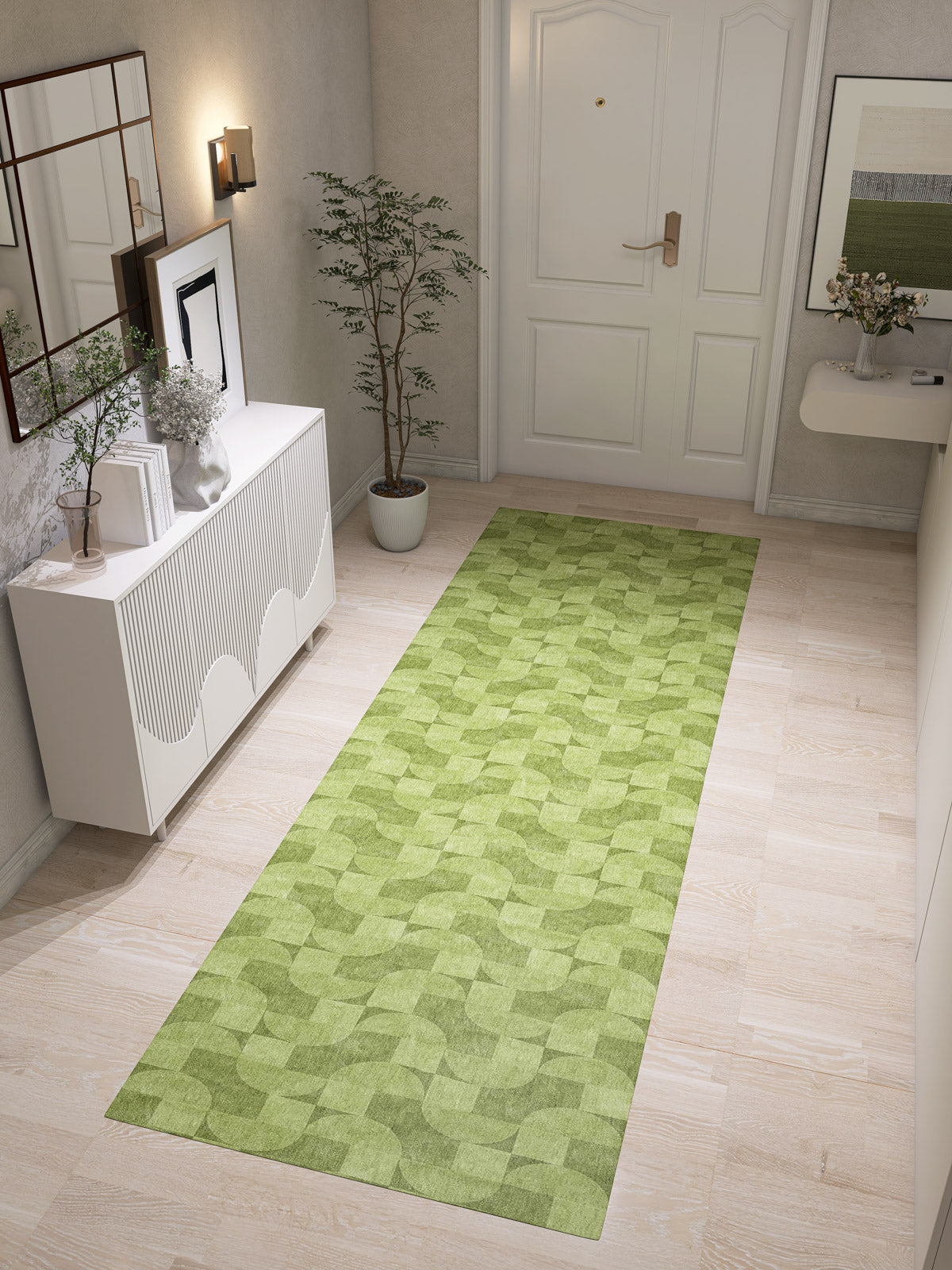 A modern hallway with light wood floors, white walls, and the Aged Serenity - Washable Rug - JRN51 featuring a geometric pattern; paired with a white console table, decor accents, potted plant, wall art, and a closed white door—ideal for contemporary interiors.
