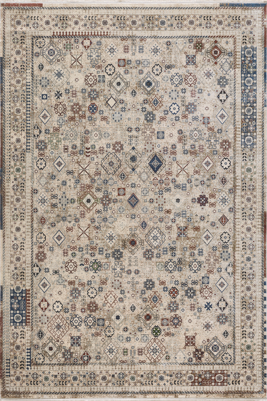 The Aged Treasures Premium Rug - 2181A is a large rectangular rug featuring an intricate geometric pattern in beige, brown, blue, and red hues, accented by a decorative border.