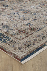 The Aged Treasures Premium Rug - 2181A is a beige geometric rug with blue, red, and brown patterns, a detailed border, and cream fringe. This machine-made rug lies on a light wooden floor for an elegant look.