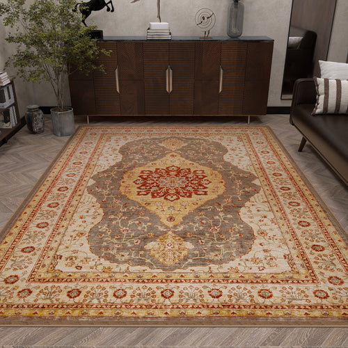 Load image 1 in gallery view. A living room features the Amber Stone - Washable Rug - JRS026 in beige, red, gold, and gray on a herringbone wood floor, paired with a modern sideboard, potted plant, and dark sofa with striped cushions for a contemporary look.