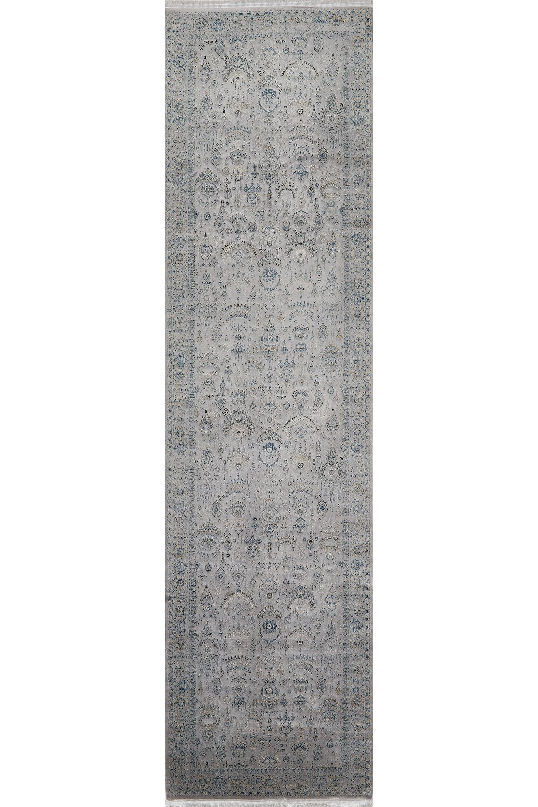 The Ancestral Motifs Turkish Rug - 2225C is a long, rectangular machine-made rug with an intricate floral and medallion design in muted gray, blue, and beige tones. Crafted from modal silk-polyester, it offers a classic, elegant look.
