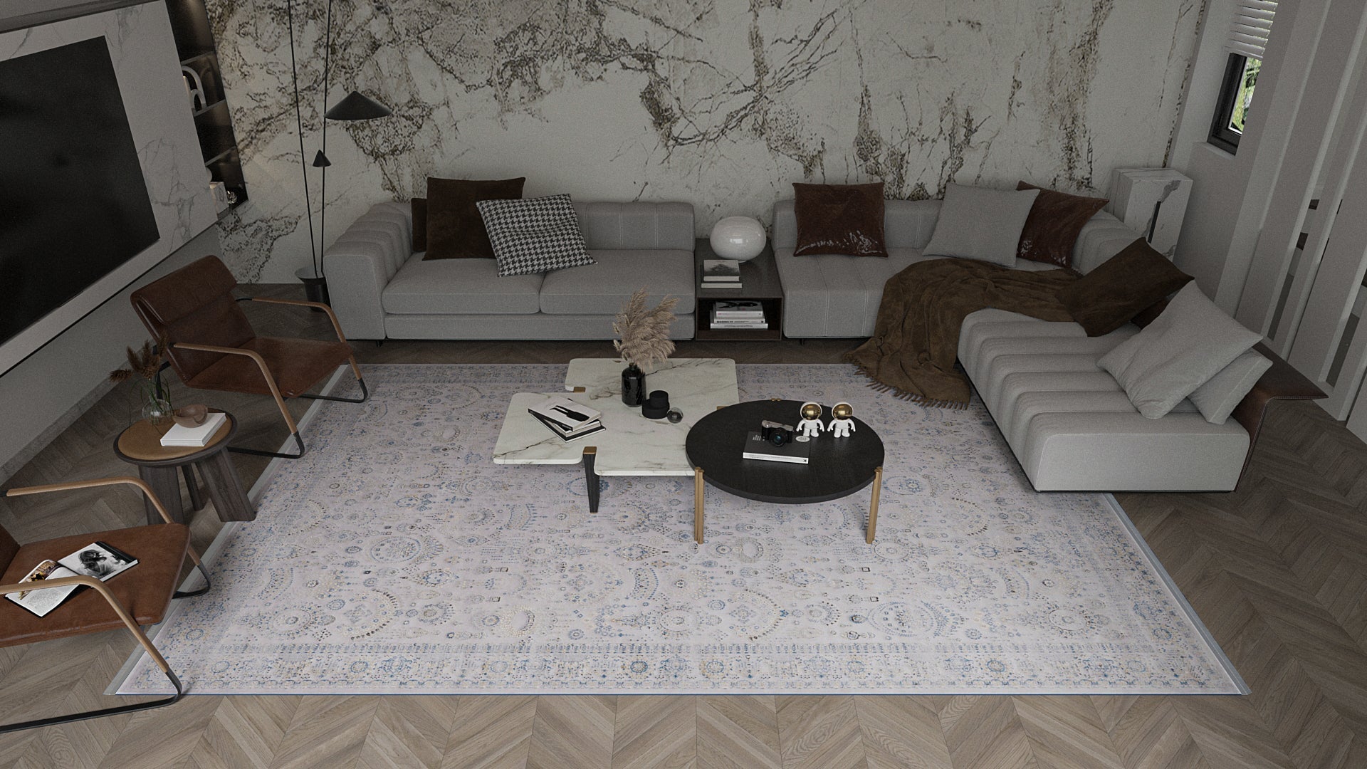 Modern living room featuring two gray sofas, brown leather chairs, and the Ancestral Motifs Turkish Rug - 2225C. A rectangular table with decor and a round table with figurines rest on the wood floor, set against an elegant marble-effect wall.