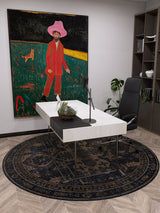 A modern office features a white desk, black chair, and the Ancient Legacy - Washable Rug - JR1890, ideal for high-traffic areas. A vibrant painting, shelves, and a plant add color and life to the space.