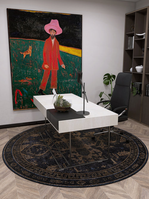 Load image 1 in gallery view. A modern office features a white desk, black chair, and the Ancient Legacy - Washable Rug - JR1890, ideal for high-traffic areas. A vibrant painting, shelves, and a plant add color and life to the space.