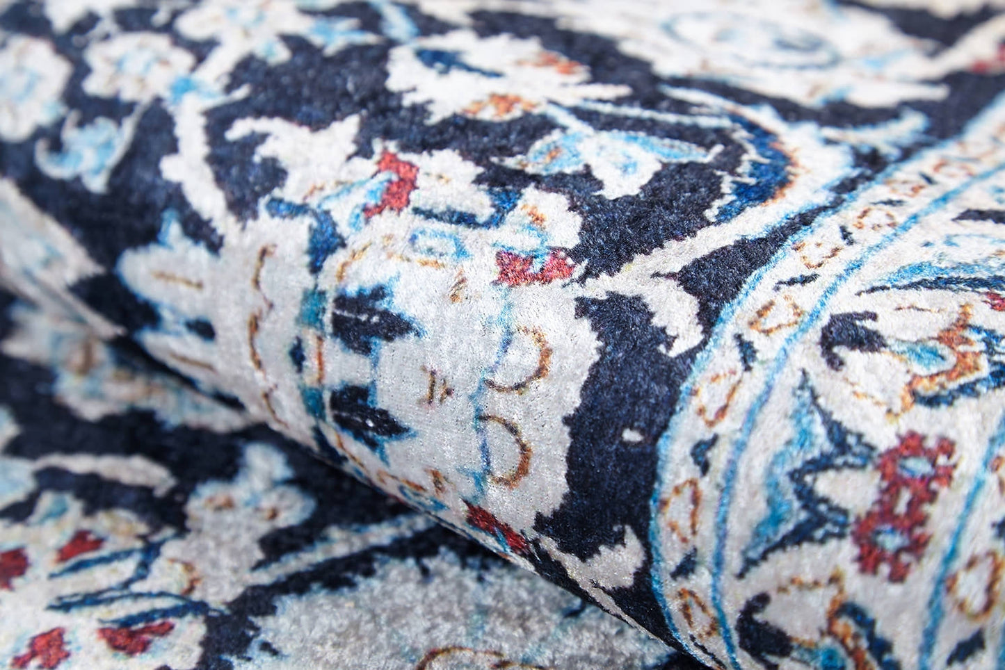 Close-up of the Antique Enchantment - Washable Rug - JR1686 (Custom Size) shows intricate floral and geometric patterns in blue, white, and cream with red and gold accents. The allergy-friendly, ornate flat weave reveals fine texture and detailed craftsmanship.