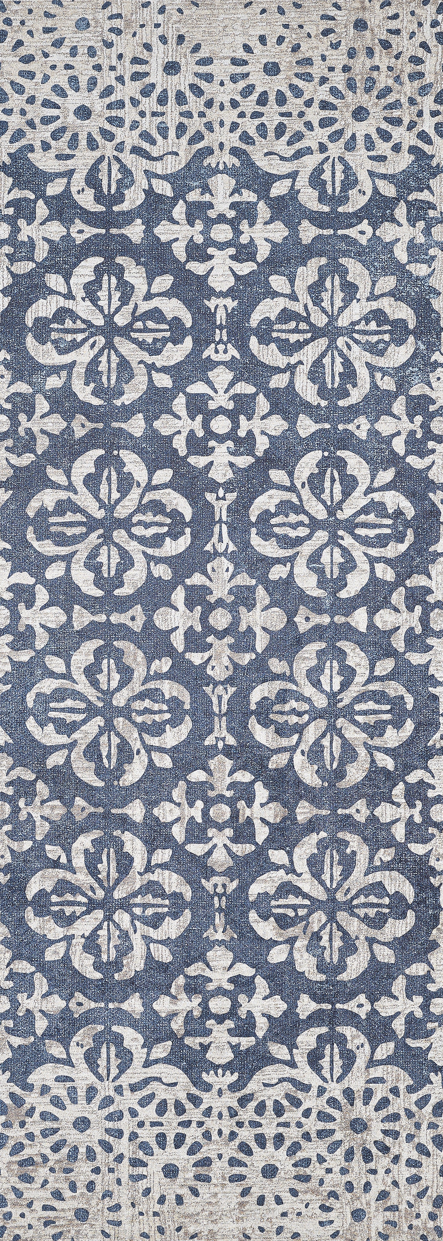 The Antique Flourish - Washable Rug - JR1591 features a blue base with an ornate white floral pattern, distressed details for a vintage look, and durable washable construction—ideal for high-traffic areas.