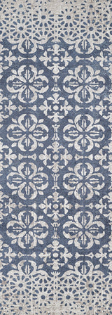 The Antique Flourish - Washable Rug - JR1591 features a blue base with an ornate white floral pattern, distressed details for a vintage look, and durable washable construction—ideal for high-traffic areas.